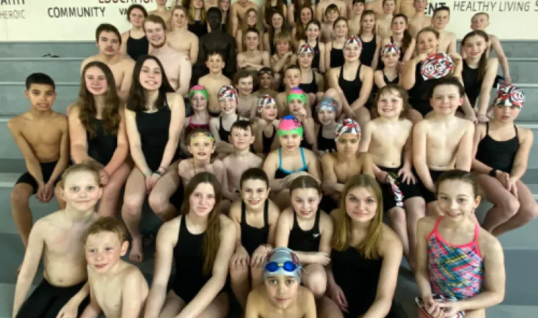 DCY state swim team members pose on the mezzanine