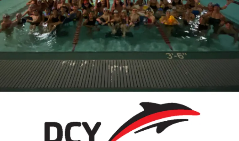 DCY swim team members who participated in the 2023 Midnight Swim kickoff event pose in the pool
